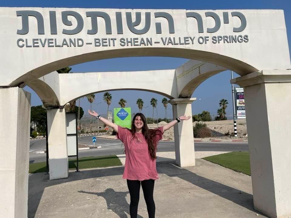 Partnership: Ellie Shafron in front of the Cleveland-Beit Shean partnership sign at a traffic circle in Beit Shean. 

Submitted photo